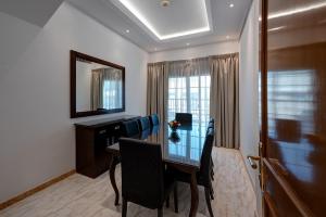 a dining room with a table and chairs and a mirror at J5 Four Bedroom Villa Holiday home in Mirdif in Dubai