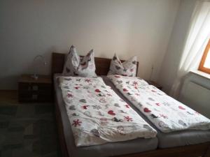 a bed with a white comforter and pillows at Ferienwohnung Elgert in Scheidegg