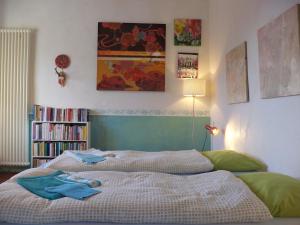 a bedroom with a bed and a book shelf at B&B Casa Codega in Intragna