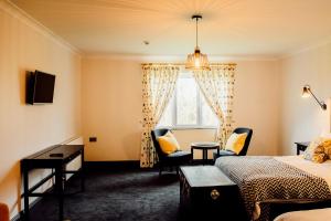 a hotel room with two beds and a window at Ballycannon Lodge in Croagh