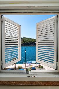 a window with a view of a body of water at Apartman More in Novigrad Dalmatia