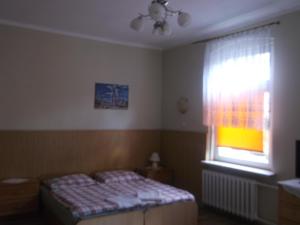 a bedroom with a bed and a window at Góściniec Iwona in Głuchołazy