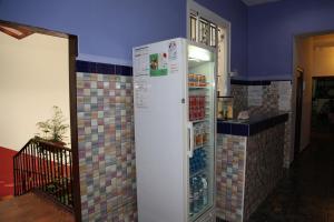 a refrigerator in a room with tiles on the wall at Central Station Hostel Barcelona in Barcelona