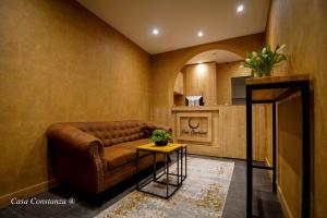 a living room with a brown couch and a table at Casa Constanza Hotel Garni in Friedrichshafen