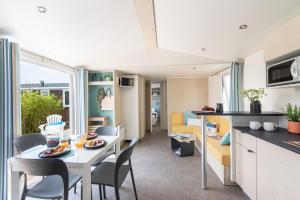 a kitchen and living room with a table and chairs at Lake Park in Berlare