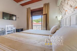 Кровать или кровати в номере Dulce Nombre Hotel - Apartamentos