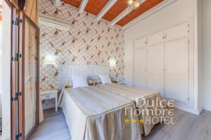 Кровать или кровати в номере Dulce Nombre Hotel - Apartamentos