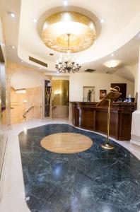 a lobby with a marble floor and a chandelier at Hotel Opera by Zeus International in Bucharest