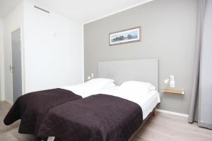 Postel nebo postele na pokoji v ubytování Napoli Resturant & Hotell AS