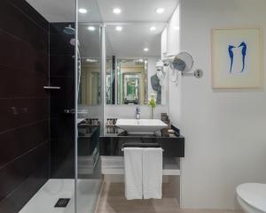 a bathroom with a sink and a shower at H10 Gran Tinerfe - Adults Only in Adeje