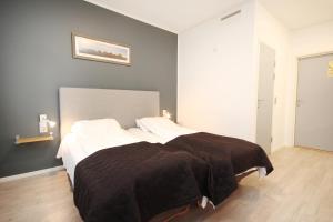 Postel nebo postele na pokoji v ubytování Napoli Resturant & Hotell AS