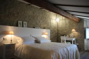 a bedroom with a large bed and a table with a desk at B&B Antico Mulino in Camugnano