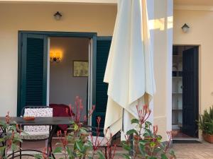 a patio with a table and an umbrella at Villino Eleonora in Parghelia