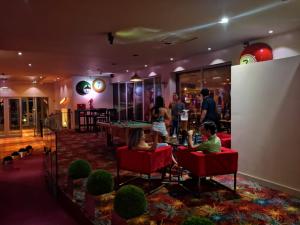 a group of people in a room with a pool table at 7 Saltos Resort in Salto del Guairá