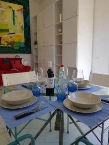 a dining table with plates and wine glasses on it at Villino I Sugheri in Marciana Marina