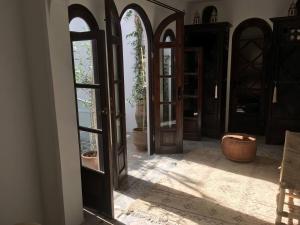 an open hallway with doors and potted plants at Dar 23 in Tangier