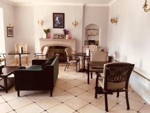 a living room with chairs and a table and a fireplace at Brass Castle Country House Accommodation in Middlesbrough