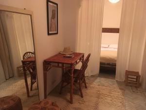 a small table and chairs in a room with a bed at Dar 23 in Tangier