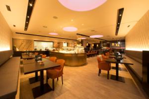 a restaurant with tables and chairs and a bar at Hotel Locker & Legere - Self Check-in am Wochenende in Sankt Ruprecht an der Raab