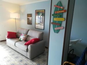 蒙泰羅索阿爾馬雷的住宿－Costamare，客厅配有沙发和墙上的标志