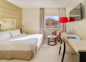 a hotel room with two beds and a window at H10 Gran Tinerfe - Adults Only in Adeje