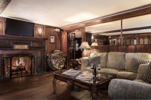 a living room with a couch and a fireplace at The Huntting Inn in East Hampton