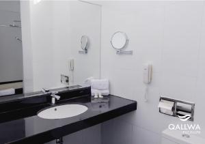 uma casa de banho com um lavatório e um espelho em Qallwa Pucallpa em Pucallpa