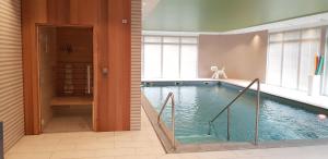 a large swimming pool in a room with at DOMITYS L'AIGRETTE BLEUE in Abbeville