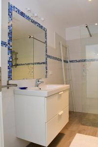 a bathroom with a white sink and a mirror at Casa Sara in Acireale