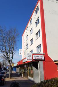 a red and white building on a city street at Hotel Sonne - Haus 1 in Idstein