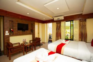 a hotel room with two beds and a television at Hotel Splendid View in Pokhara