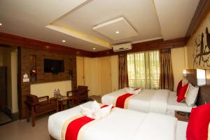 a hotel room with two beds and a television at Hotel Splendid View in Pokhara