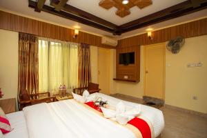 a bedroom with a large white bed in a room at Hotel Splendid View in Pokhara