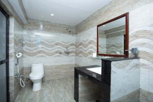 a bathroom with a sink and a toilet and a mirror at Hotel Splendid View in Pokhara