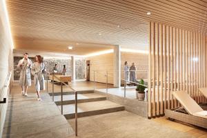 two women walking down a staircase in a house at Hotel die Wälderin-Wellness, Sport & Natur in Mellau