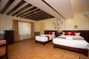 a hotel room with two beds and a couch at Hotel Splendid View in Pokhara