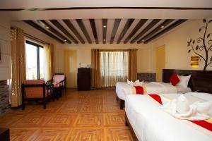 a large room with two beds in a room at Hotel Splendid View in Pokhara