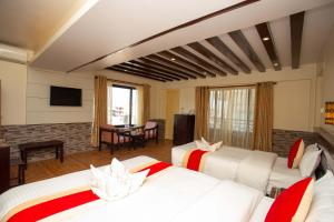 a hotel room with two beds and a television at Hotel Splendid View in Pokhara