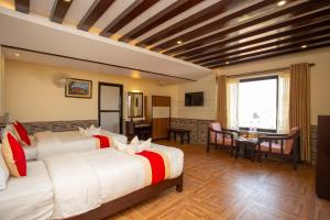 a hotel room with two beds and a table at Hotel Splendid View in Pokhara