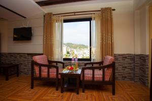 a dining room with a table and chairs and a window at Hotel Splendid View in Pokhara