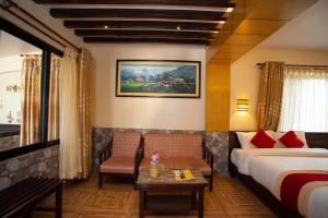 a hotel room with a bed and a coffee table at Hotel Splendid View in Pokhara