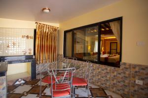 a dining room with a table and chairs and a mirror at Hotel Splendid View in Pokhara