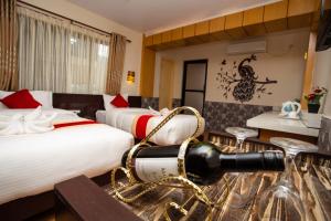 a hotel room with two beds with a cannon on the floor at Hotel Splendid View in Pokhara