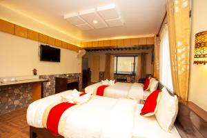 a hotel room with three beds and a fireplace at Hotel Splendid View in Pokhara