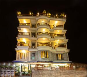 a tall white building with lights on at Hotel Splendid View in Pokhara
