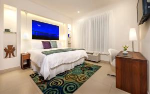 A bed or beds in a room at Elements Hotel Boutique