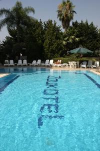 a swimming pool with a reflection of a person in the water at Zoukotel Hotel in Jounieh