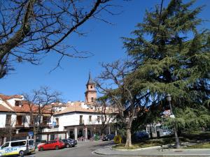 a street in a town with a clock tower at Apartamentos Deluxe Barajas in Madrid