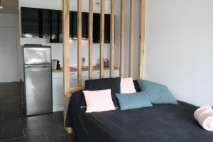 a room with a bed with three pillows on it at Studio Naturiste P.Nature 6 in Cap d'Agde