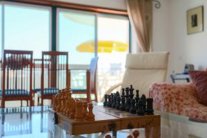 a chess set on a table in a living room at Sotto Mayor Residence in Figueira da Foz